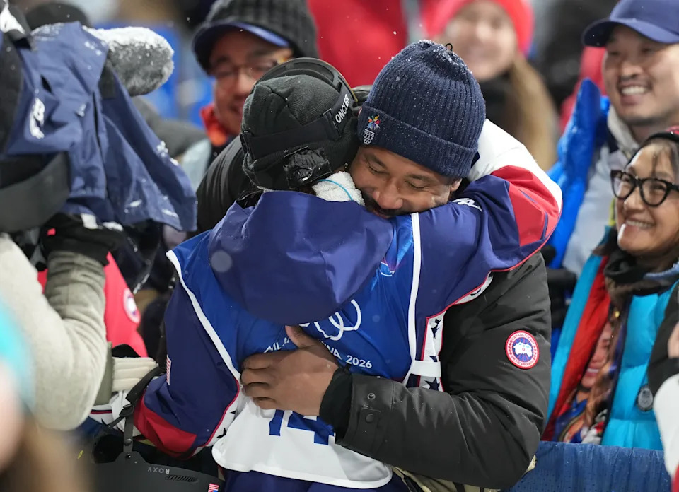 Chloe Kim of the United States gets a hug from Cleveland Browns player Myles Garrett.