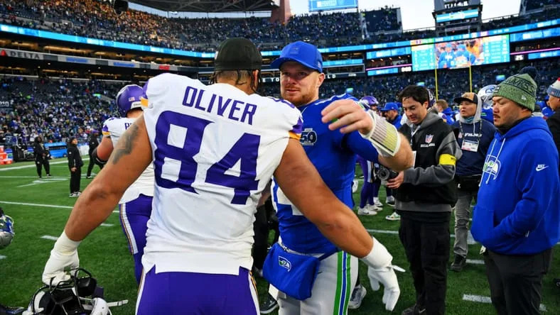 Seahawks QB Sam Darnold and TE Josh Oliver embrace in 2025