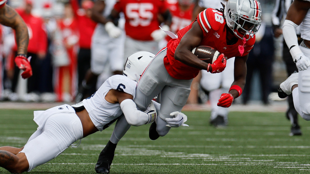 Penn State defensive back Zakee Wheatley, left, tackles Ohio State receiver Marvin Harrison during the first half of an NCAA college football game Saturday, Oct. 21, 2023, in Columbus, Ohio. (AP Photo/Jay LaPrete)
