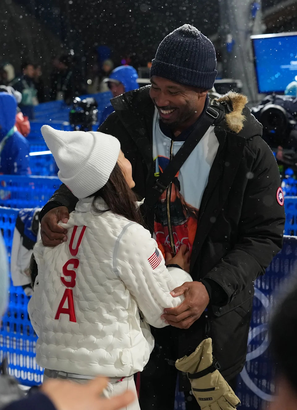Cleveland Browns player Myles Garrett greets Chloe Kim of the United States after the women's halfpipe final.