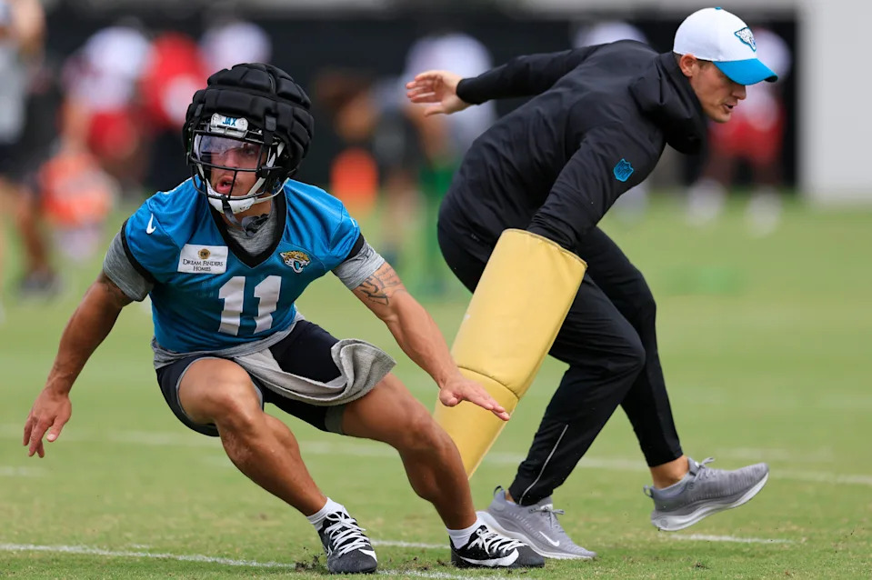 Jacksonville Jaguars wide receiver Parker Washington (11) is pressured by assistant wide receivers coach, passing game specialist Tyler Tettleton during a combined NFL football training camp session between the Tampa Bay Buccaneers and Jacksonville Jaguars Thursday, Aug. 15, 2024 at EverBank Stadiumâ€™s Miller Electric Center in Jacksonville, Fla. [Corey Perrine/Florida Times-Union]
