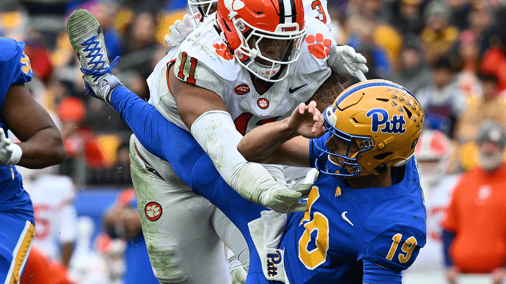 Nate Yarnell #19 of the Pittsburgh Panthers is knocked down as he throws by Peter Woods #11 of the Clemson Tigers in the second half during the game at Acrisure Stadium on November 16, 2024 in Pittsburgh, Pennsylvania.  (Photo by Justin Berl/Getty Images)