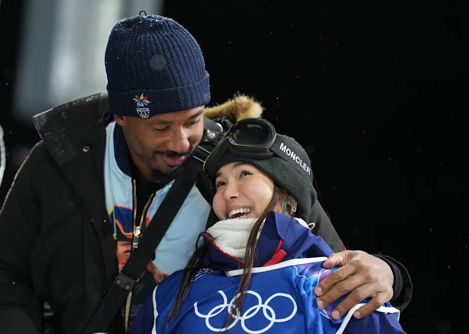 Chloe Kim of the United States with Cleveland Browns player Myles Garrett after her second run.