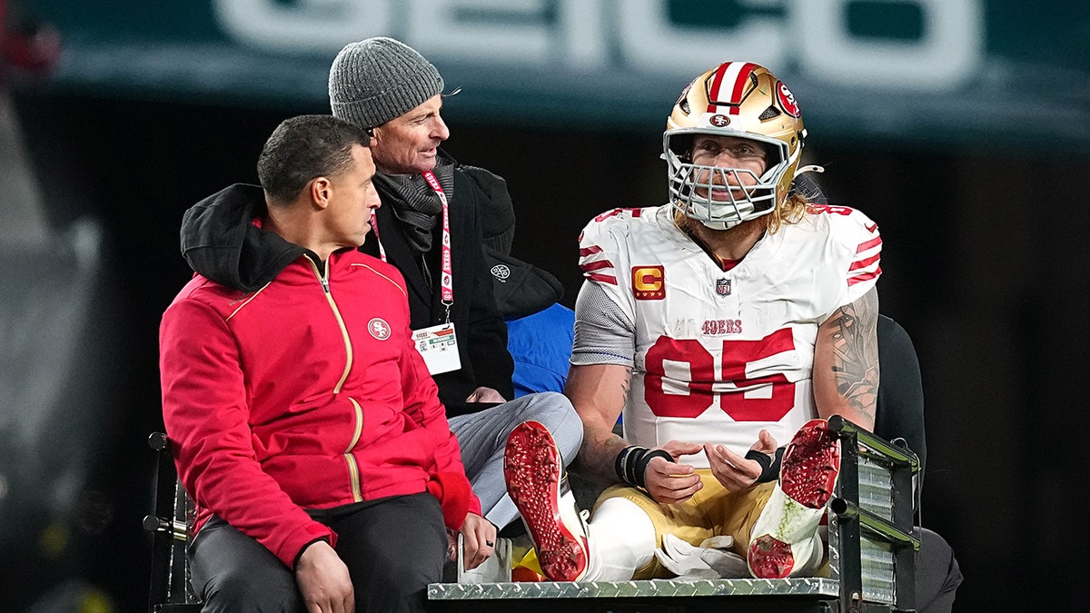 George Kittle carted off field