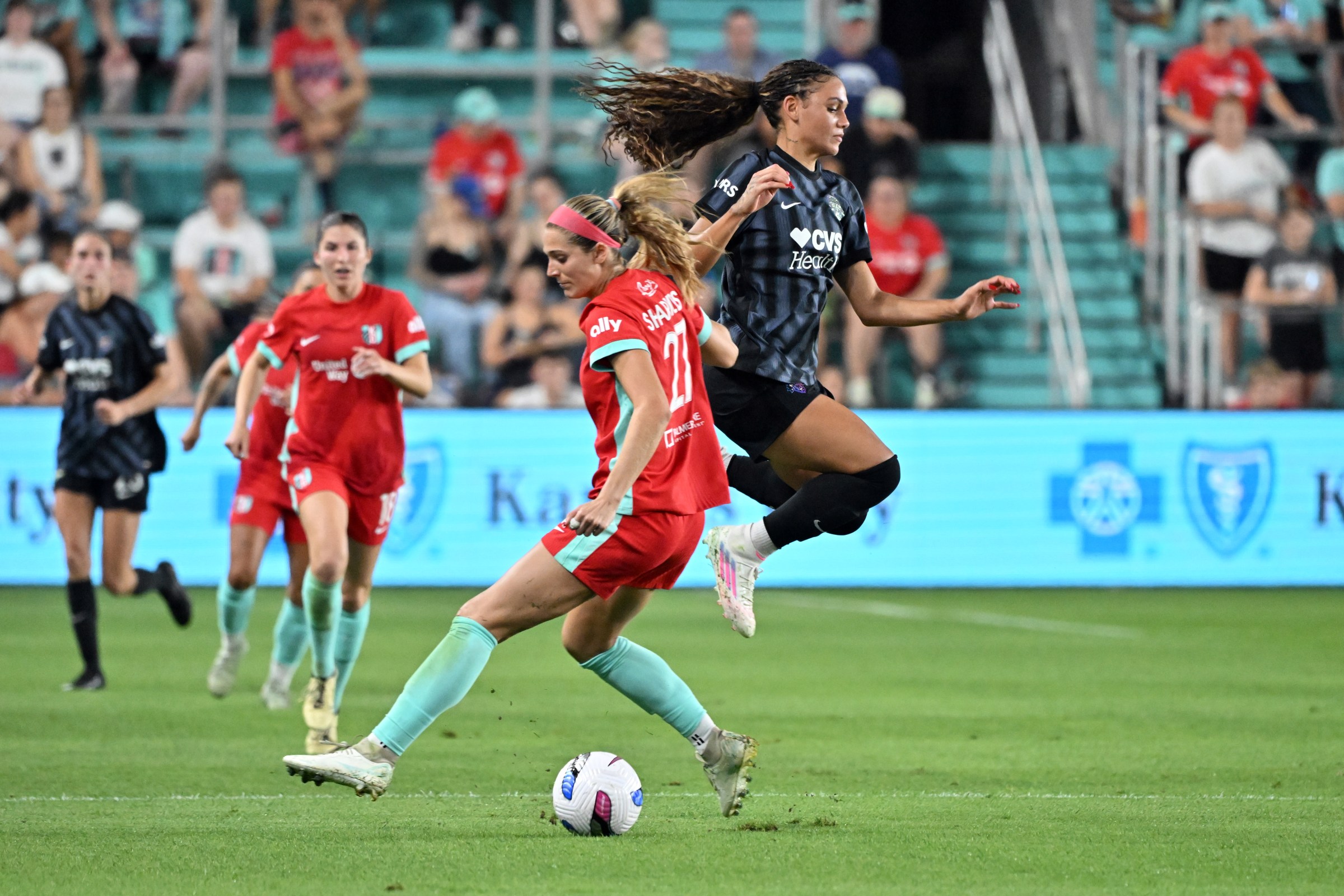 KANSAS CITY, MISSOURI - SEPTEMBER 13: Kayla Sharples #27 of Kansas City Current and Trinity Rodman #2 of Washington Spirit collide during the second half of a NWSL game between Kansas City Current and Washington Spirit at CPKC Stadium on September 13, 2025 in Kansas City, Missouri. (Photo by Bill Barrett/ISI Photos/ISI Photos via Getty Images)