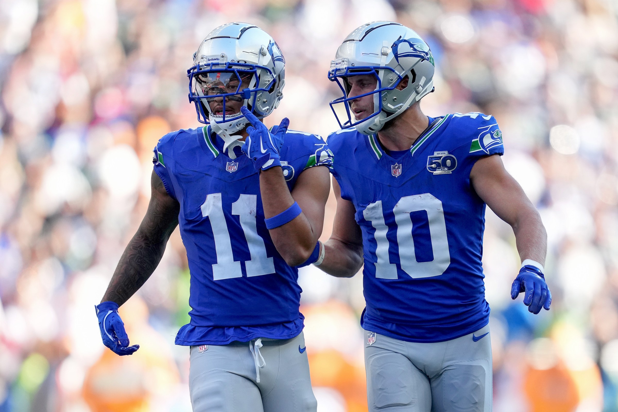 SEATTLE, WASHINGTON - OCTOBER 05: Jaxon Smith-Njigba #11 and Cooper Kupp #10 of the Seattle Seahawks talk during the second half against the Tampa Bay Buccaneers at Lumen Field on October 05, 2025 in Seattle, Washington. (Photo by Soobum Im/Getty Images)
