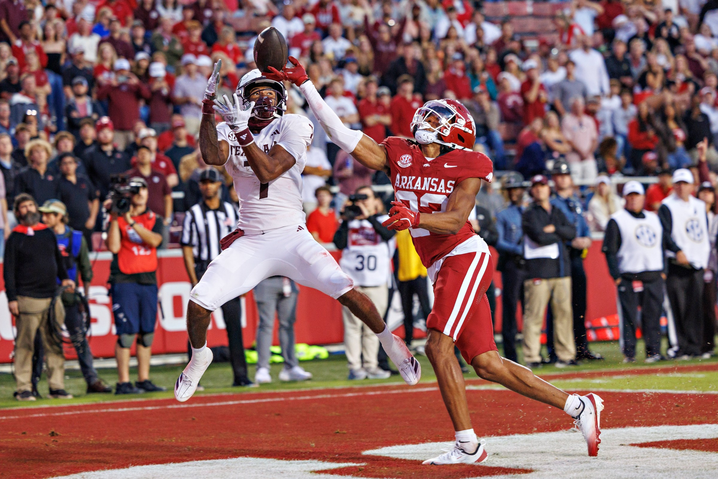 FAYETTEVILLE, ARKANSAS - OCTOBER 18: Julian Neal #23 of the Arkansas Razorbacks tips a pass in the end zone in the second half that was thrown to KC Concepcion #7 of the Texas A&M Aggies at Donald W. Reynolds Razorback Stadium on October 18, 2025 in Fayetteville, Arkansas. The Aggies defeated the Razorbacks 45-42. (Photo by Wesley Hitt/Getty Images)