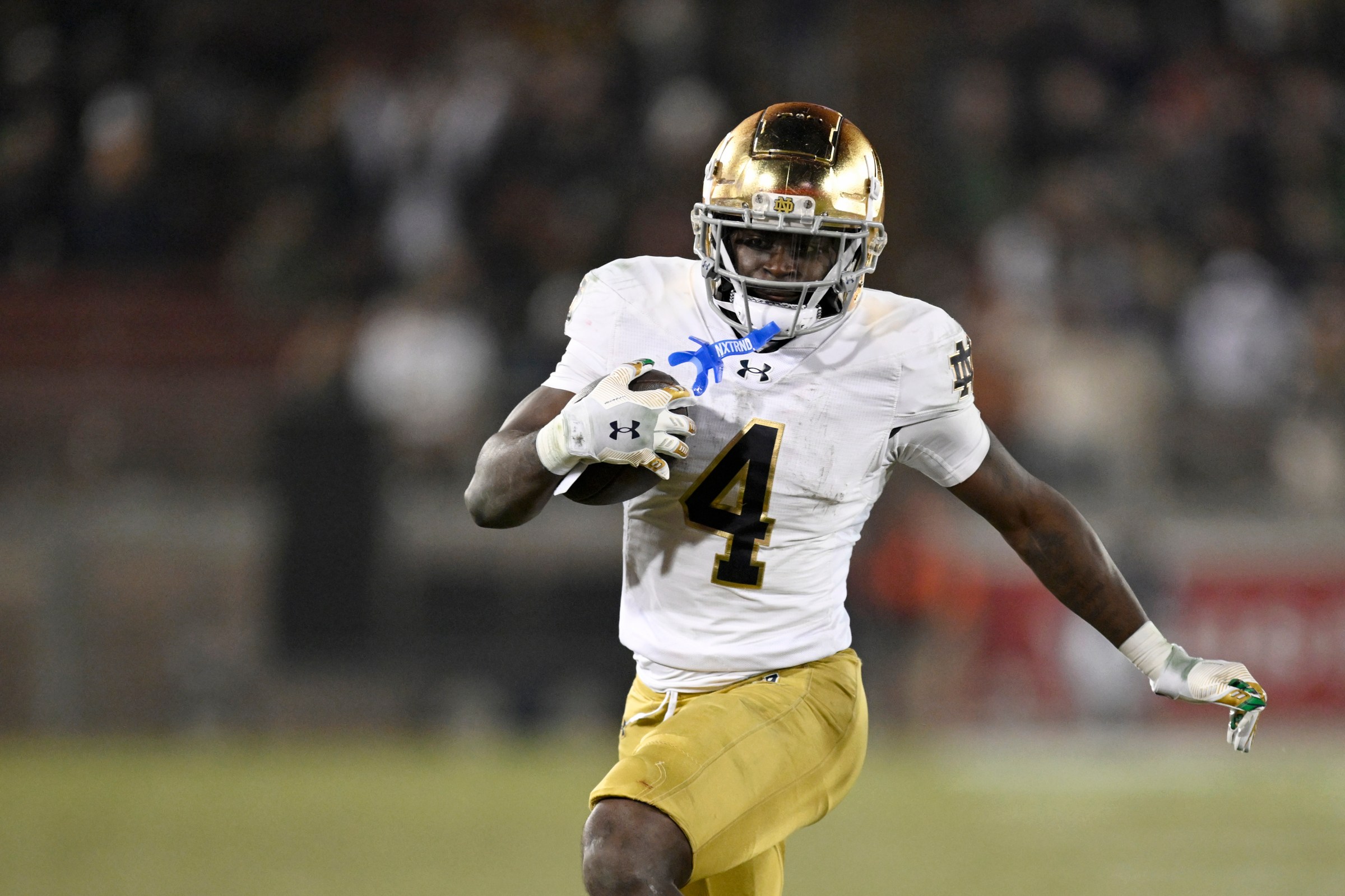 STANFORD, CALIFORNIA - NOVEMBER 29: Jeremiyah Love #4 of the Notre Dame Fighting Irish runs the ball against the Stanford Cardinal in the third quarter at Stanford Stadium on November 29, 2025 in Stanford, California. (Photo by Eakin Howard/Getty Images)