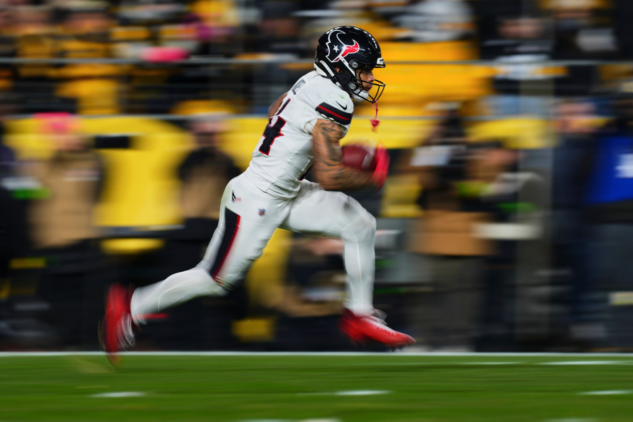 PITTSBURGH, PA - JANUARY 12: Jaylin Noel #14 of the Houston Texans carries the ball against the Pittsburgh Steelers during the first half of an AFC Wild Card Playoff game at Acrisure Stadium on January 12, 2026 in Pittsburgh, Pennsylvania. (Photo by Cooper Neill/Getty Images)