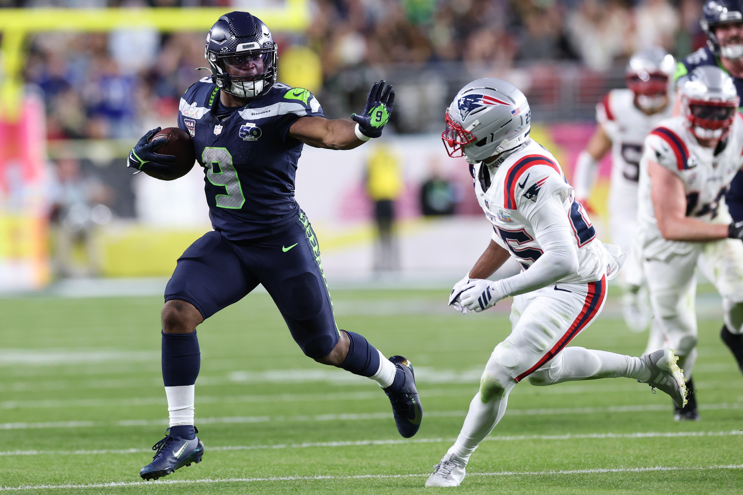 SANTA CLARA, CALIFORNIA - FEBRUARY 08: Kenneth Walker III #9 of the Seattle Seahawks rushes against Marcus Jones #25 of the New England Patriots during the third quarter in Super Bowl LX at Levi’s Stadium on February 08, 2026 in Santa Clara, California. (Photo by Kevin C. Cox/Getty Images)