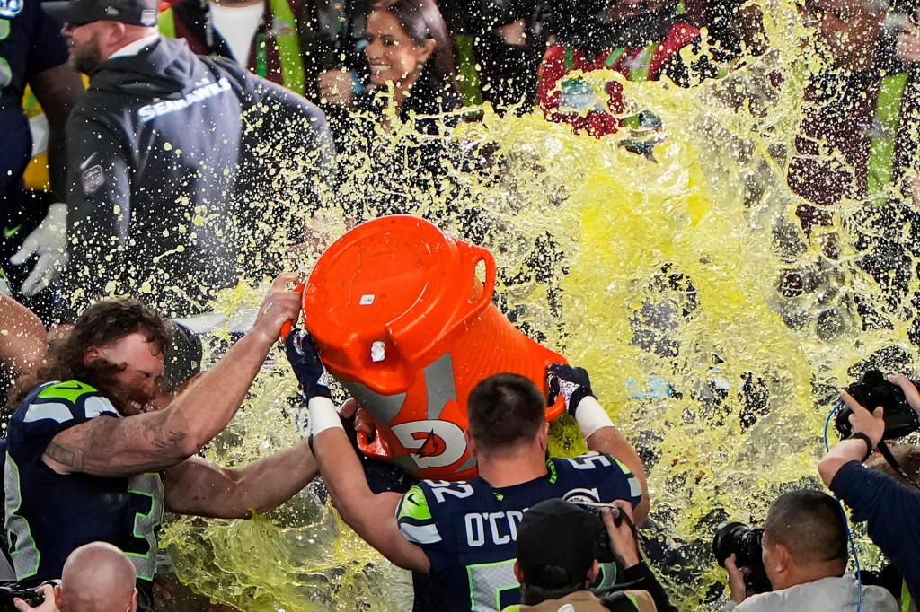 Head coach Mike MacDonald of the Seattle Seahawks is doused with Gatorade.
