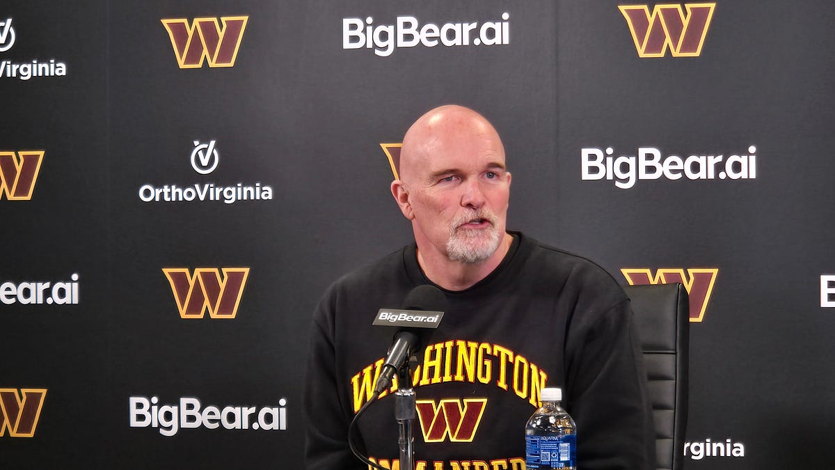 Dan Quinn, Daronte Jones and David Blough walk into a press conference...