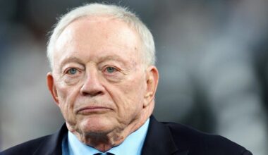 A man in a suit and tie looks ahead with a serious expression as head of the Dallas Cowboys.