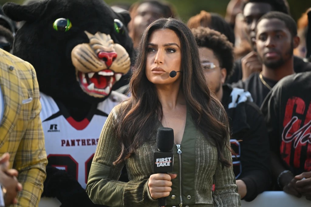 Molly Qerim holding a microphone with a panther mascot in the background.