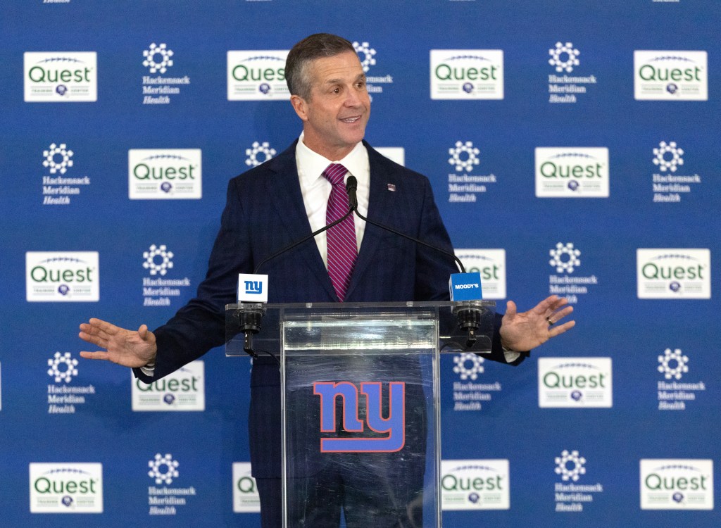 John Harbaugh speaking at a press conference where he was introduced as the new head coach for the New York Giants.