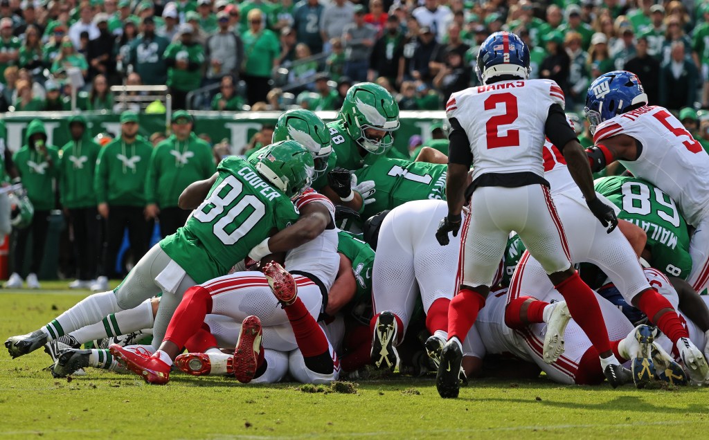 Philadelphia Eagles quarterback Jalen Hurts #1 runs a tush push play against the New York Giants.
