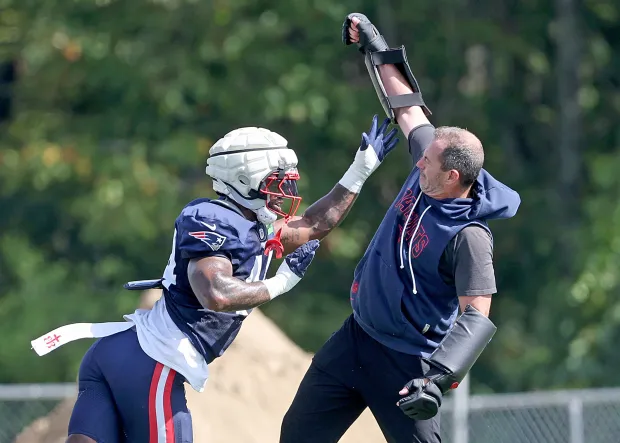 Linebacker K'Lavon Chaisson of the New England Patriots with assistant coach Mike Smith during practice at Gillette Stadium. (Photo By Matt Stone/Boston Herald)