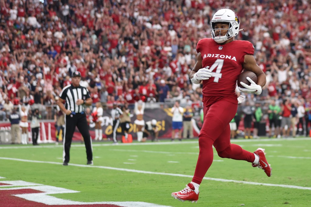 Arizona Cardinals player Rondale Moore #4 running with the football for a touchdown.