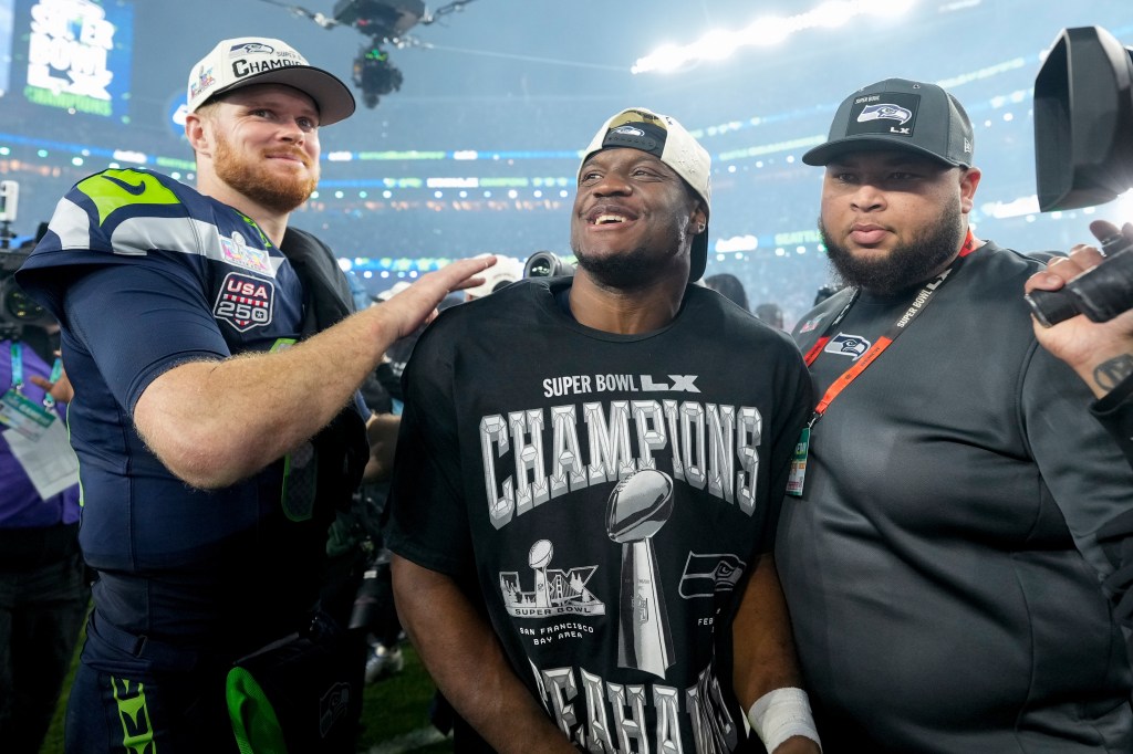 Seattle Seahawks players Sam Darnold and Kenneth Walker III celebrate their Super Bowl 60 victory.