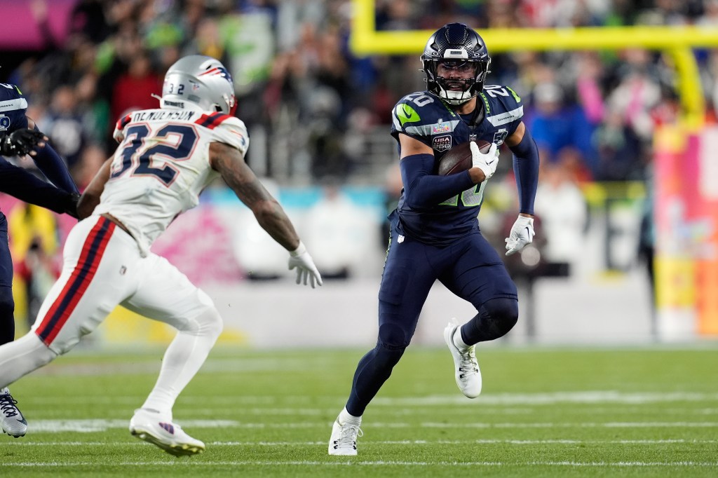 Julian Love returns an interception against TreVeyon Henderson during Super Bowl 60.