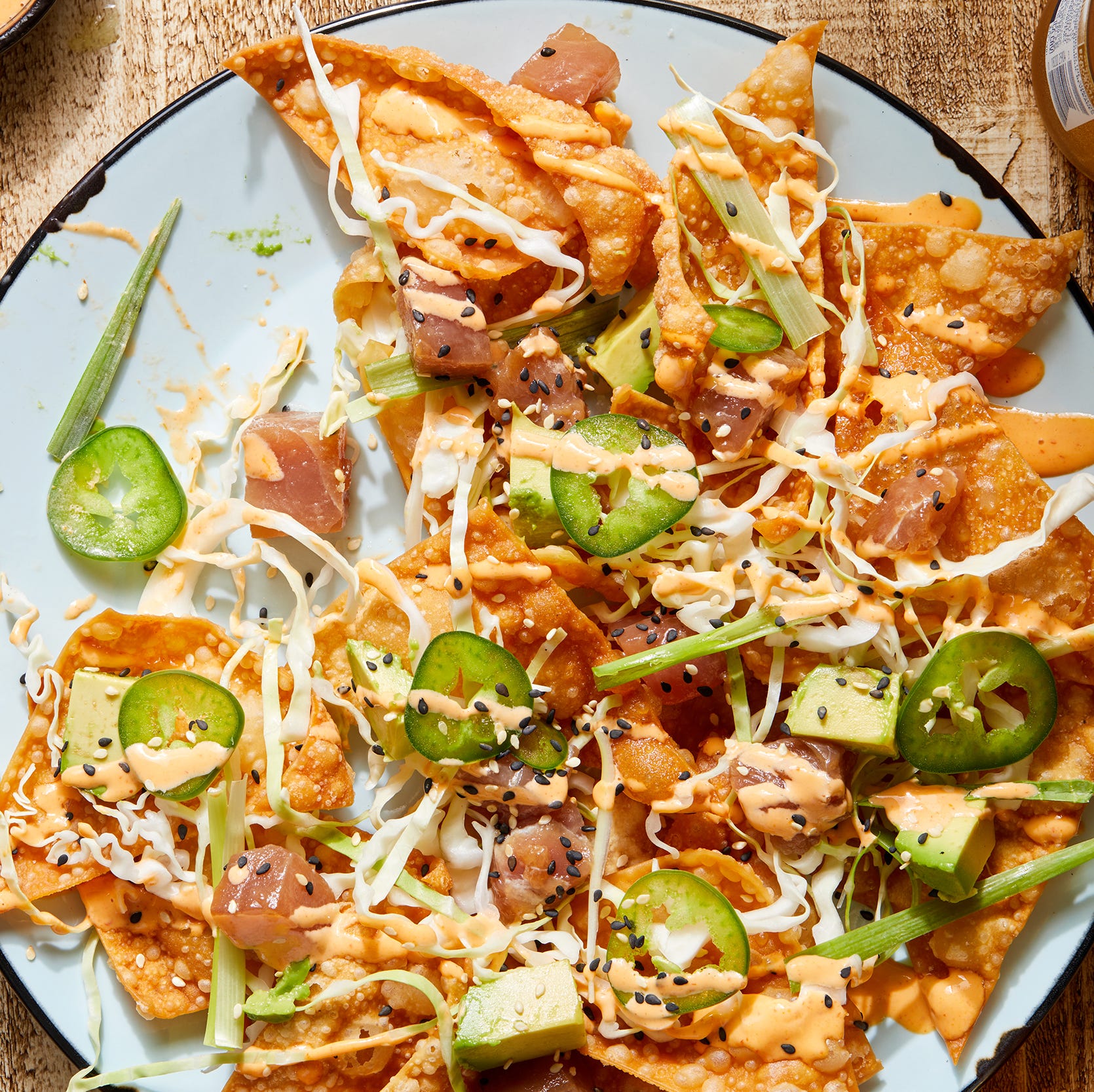 spicy ahi tuna nachos with cabbage, scallions and sesame seeds