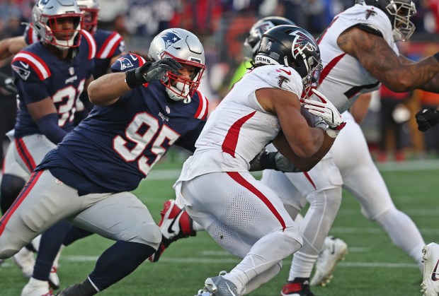 New England Patriots defensive tackle Khyiris Tonga (95) chases down Atlanta Falcons running back Bijan Robinson during the fourth quarter of a game at Gillette Stadium. (Nancy Lane/Boston Herald)