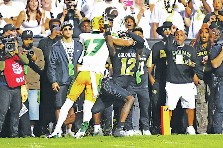 RON CHENOY / USA TODAY / AUG. 29, 2024
Colorado Buffaloes wide receiver Travis Hunter (12) pulls in a touchdown reception past North Dakota State Bison cornerback Jailen Duffie (17) in a 2024 NCAA football game in Boulder, Colo. North Dakota State is talking with the Mountain West about joining the conference as a football-only member, Yahoo Sports reported.