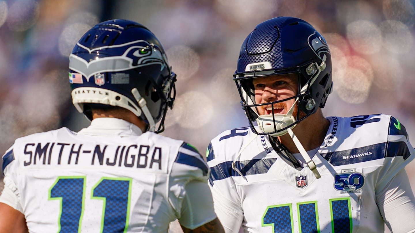 Seattle Seahawks wide receiver Jaxon Smith-Njigba celebrates with quarterback Sam Darnold