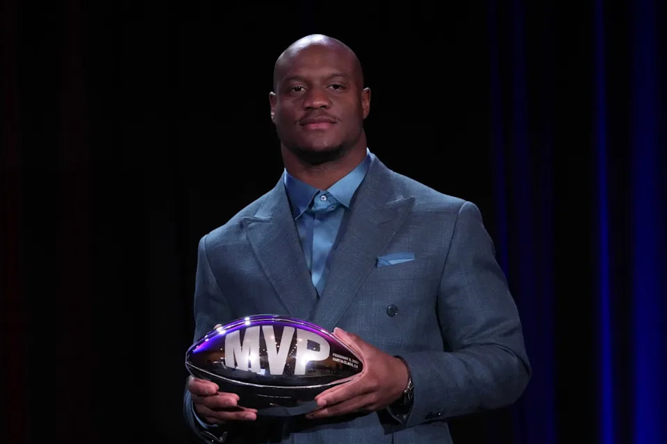 Former Seattle Seahawks running back Kenneth Walker III, now with the Kansas City Chiefs, poses with the MVP trophy.Kirby Lee-Imagn Images