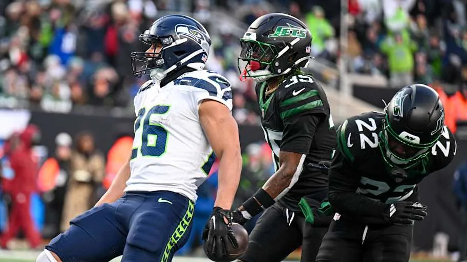 Seattle Seahawks running back Zach Charbonnet (26) celebrates scoring a touchdown