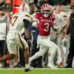 Indiana Hoosiers wide receiver Omar Cooper Jr. (3) runs down the sideline past Miami (FL) Hurricanes defenders Monday, Jan. 19, 2026, during the College Football Playoff National Championship college football game at Hard Rock Stadium in Miami Gardens.