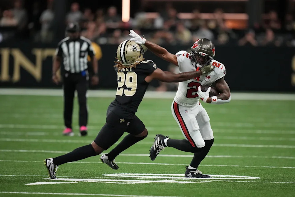 Oct 26, 2025; New Orleans, Louisiana, USA; Tampa Bay Buccaneers wide receiver Emeka Egbuka (2) runs for a gain past New Orleans Saints cornerback Quincy Riley (29) during the third quarter at Caesars Superdome. Mandatory Credit: Matthew Hinton-Imagn Images