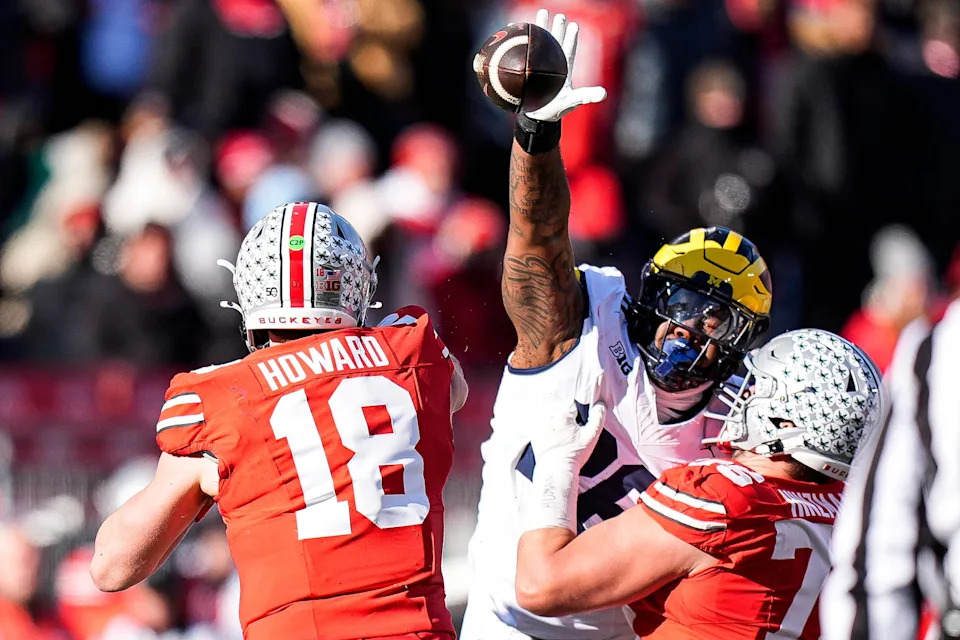 Michigan defensive lineman Rayshaun Benny (26) tries to block a pass from Ohio State quarterback Will Howard (18) during the second half at Ohio Stadium in Columbus, Ohio on Saturday, Nov. 30, 2024.