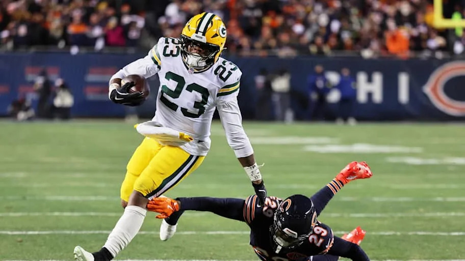 Green Bay Packers running back Emanuel Wilson runs with the ball against Chicago Bears cornerback Tyrique Stevenson