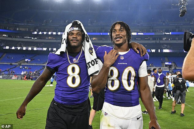 Ravens quarterback Lamar Jackson (left) puts an arm around tight end Isaiah Likely (right)