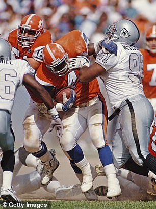 Chester McGlockton #91, Defensive Tackle for the Los Angeles Raiders tackles Derrick Clark #43, Running Back for the Denver Broncos during their American Football Conference West game on 18 September 1994 at the Mile High Stadium, Denver