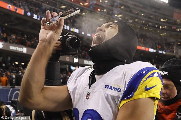 Puka Nacua takes a photo of himself with a bystander's phone after a playoff win in Chicago