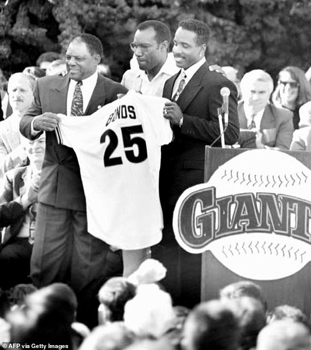 Barry Bonds is pictured with his father Bobby Bonds (near left) and godfather Willie Mays (far left) after signing a free-agent contract with the San Francisco Giants in December of 1992