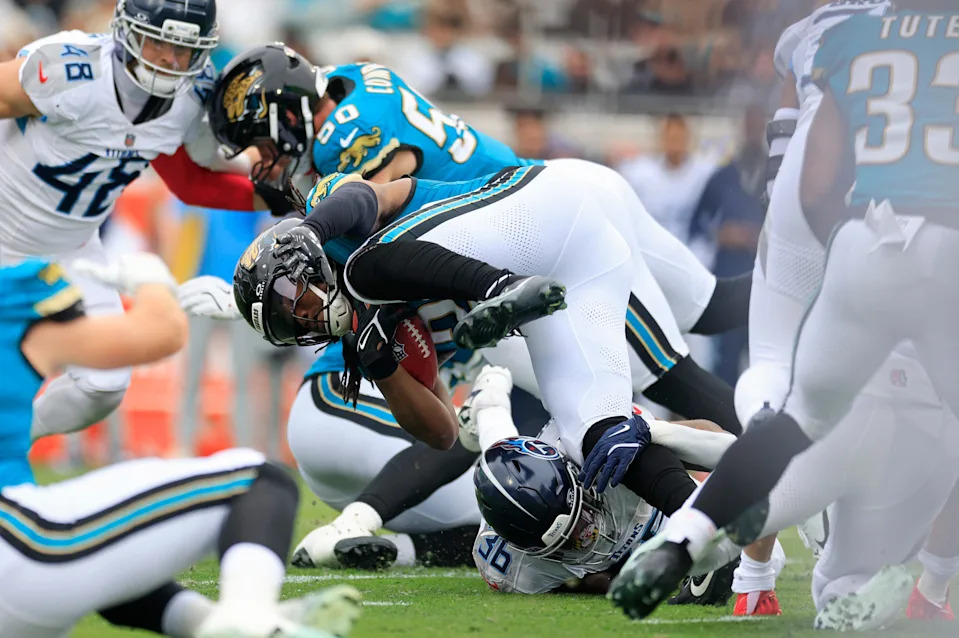 Jacksonville Jaguars running back Deejay Dallas (20) is tripped up by by Tennessee Titans running back Julius Chestnut (36) on an opening kickoff return during the first quarter of an NFL football matchup at EverBank Stadium, Sunday, Jan. 4, 2026, in Jacksonville, Fla. The Jaguars defeated the Titans 41-7, capturing the AFC South title. [Corey Perrine/Florida Times-Union]