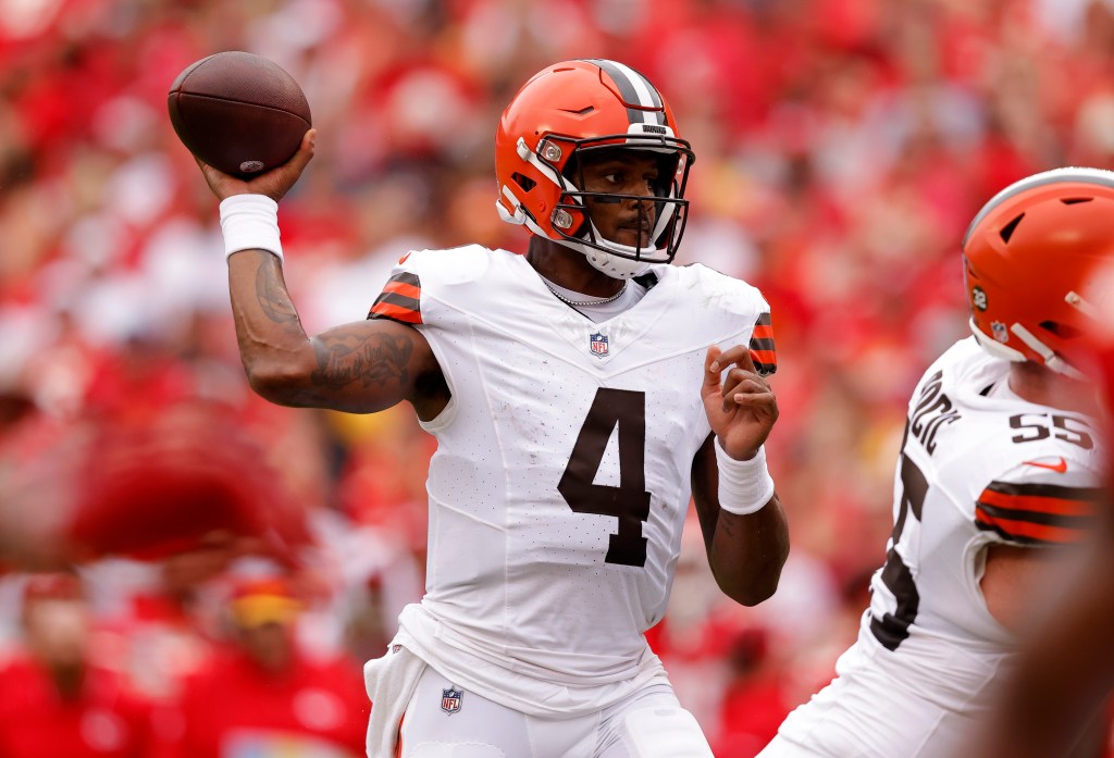 Football player Deshaun Watson, in a white jersey with the number 4 and an orange helmet, throws a football.