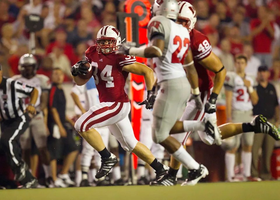 Sep 1, 2011; Madison, WI, USA; Wisconsin Badgers fullback Bradie Ewing (34) rushes with the football during the third quarter against the UNLV Rebels at Camp Randall Stadium. Mandatory Credit: Jeff Hanisch-USA TODAY Sports