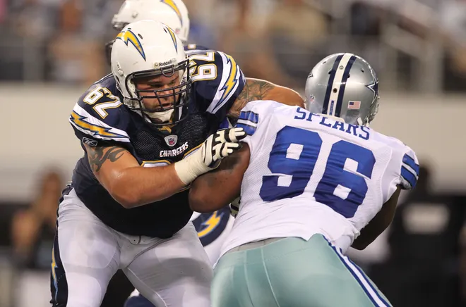 San Diego Chargers tackle Brandyn Dombrowski blocks against Dallas Cowboys defensive end Marcus Spears.