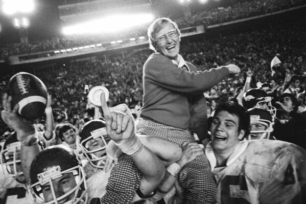 Arkansas coach Lou Holtz is carried by his players after defeating Oklahoma in the Orange Bowl NCAA college football game, Jan. 2, 1978, in Miami, Fla. (AP Photo/Phil Sandlin, File)