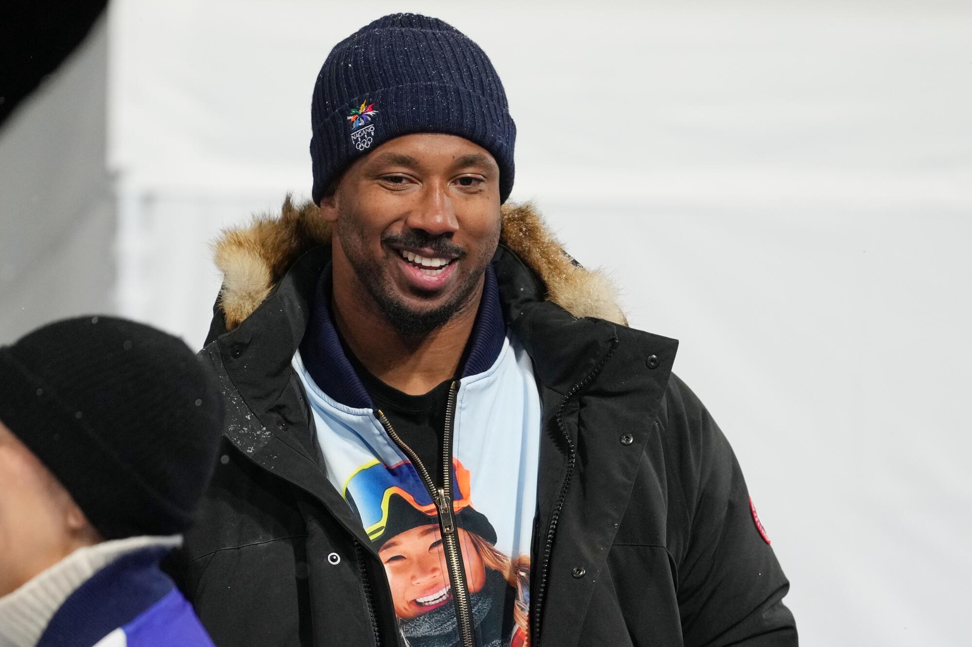 Myles Garrett wears a beanie and a heavy coat over a jacket