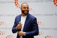 Dallas Cowboys quarterback Dak Prescott smiles as he takes the stage during a ceremony to...