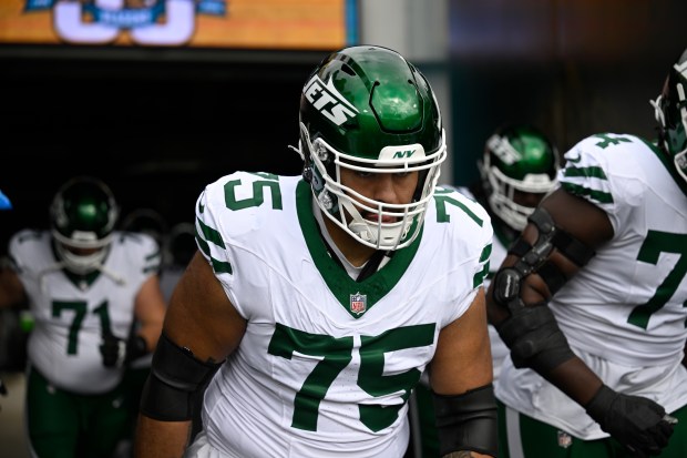 New York Jets guard Alijah Vera-Tucker (75) heads to the field before an NFL football game against the Jacksonville Jaguars, Sunday, Dec. 15, 2024, in Jacksonville, Fla. (AP Photo/Phelan M. Ebenhack)