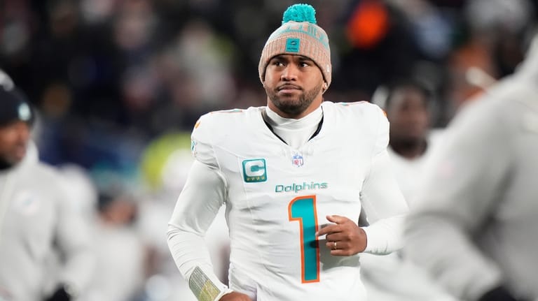 Miami Dolphins quarterback Tua Tagovailoa runs off the field during...