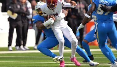 Oct 5, 2025; Inglewood, California, USA; Los Angeles Chargers defensive end Da'Shawn Hand (91) sacks Washington Commanders quarterback Jayden Daniels (5) in the first half at SoFi Stadium.