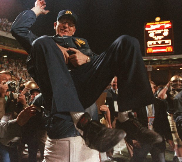 Notre Dame coach Lou Holtz is carried off the field on Jan. 2, 1989, in Tempe, Arizona, after the Fighting Irish defeated West Virginia in the Fiesta Bowl to win the national national championship. (Rob Schumacher/AP)