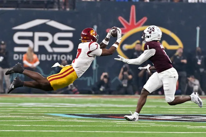 LAS VEGAS, NEVADA - DECEMBER 27: Kamari Ramsey #7 of the USC Trojans intercepts a pass intended for Jabre Barber #1 of the Texas A&M Aggies during first half of the SRS Distribution Las Vegas Bowl at Allegiant Stadium on December 27, 2024 in Las Vegas, Nevada. (Photo by David Becker/Getty Images)